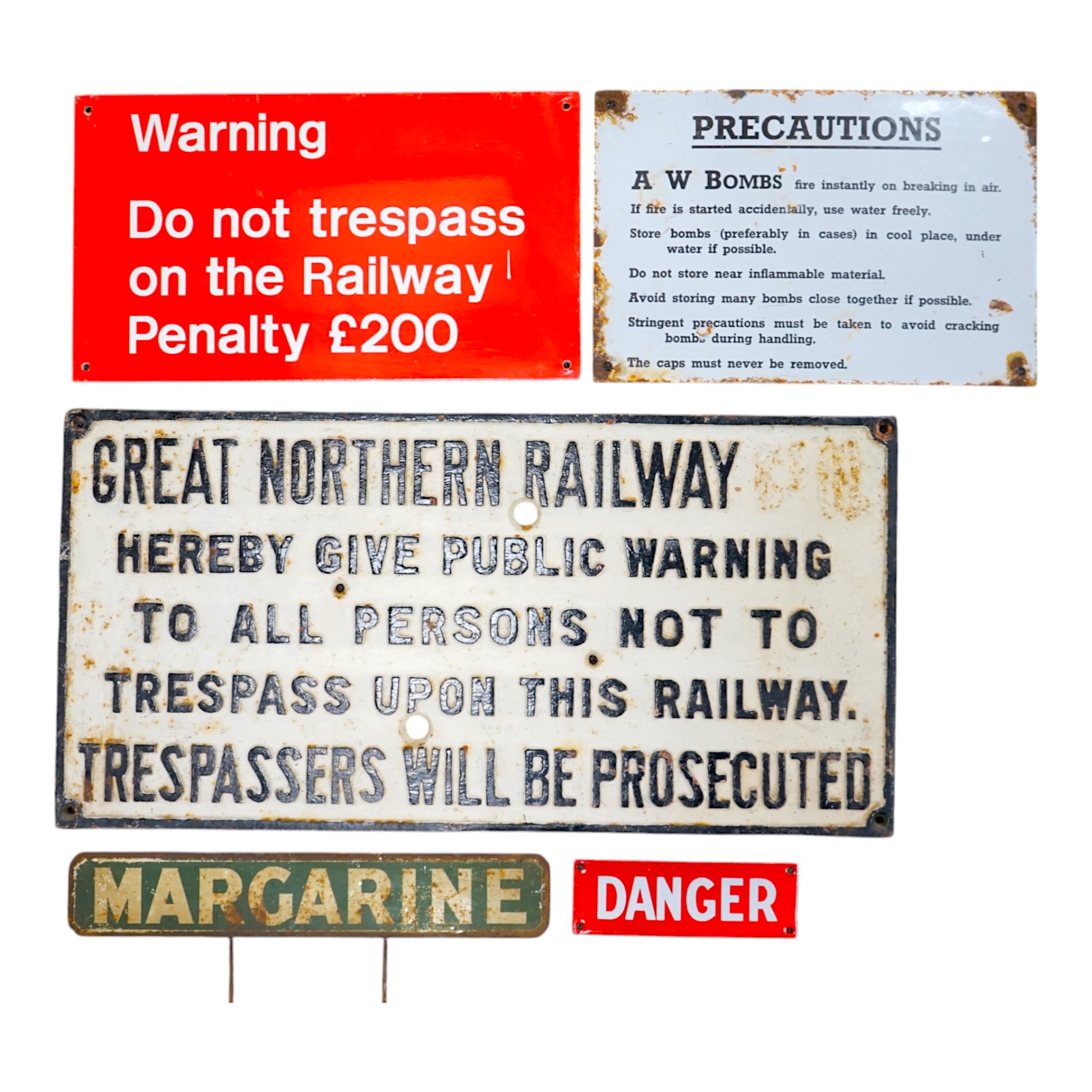 A Great Northern Railway cast iron sign; Trespassers Will Be Prosecuted, 28.5cm x 57cm, together with a WWII A W Bombs Precautions enamelled sign, a Margarine tin sign, a plastic BR Warning sign and a BR enamelled DANGER